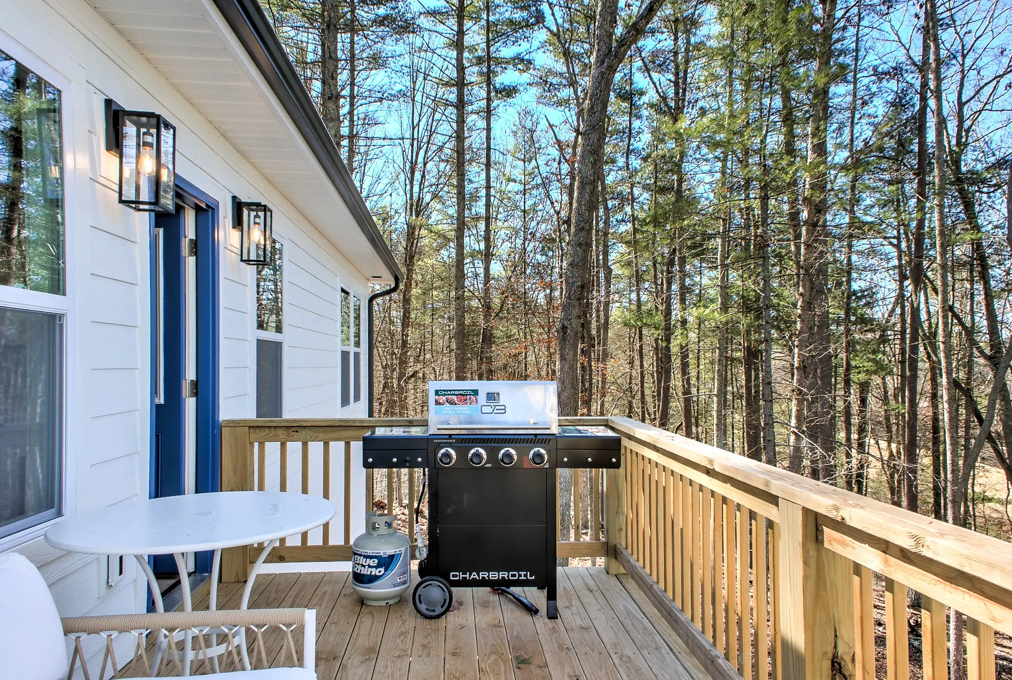 Wooded back balcony with gas grill at Oceans of Evergreen