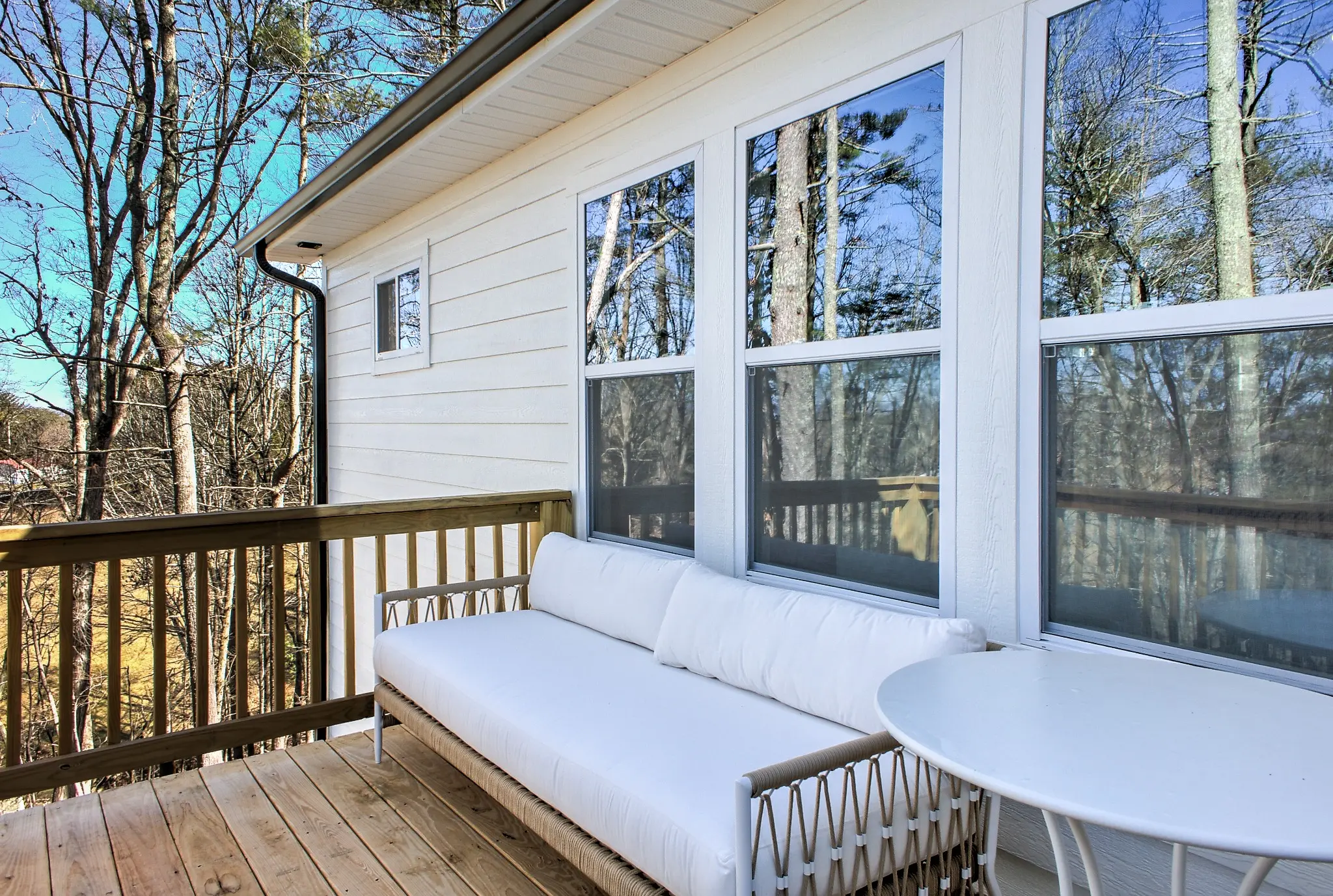 Comfortable outdoor seating on the wooded back balcony