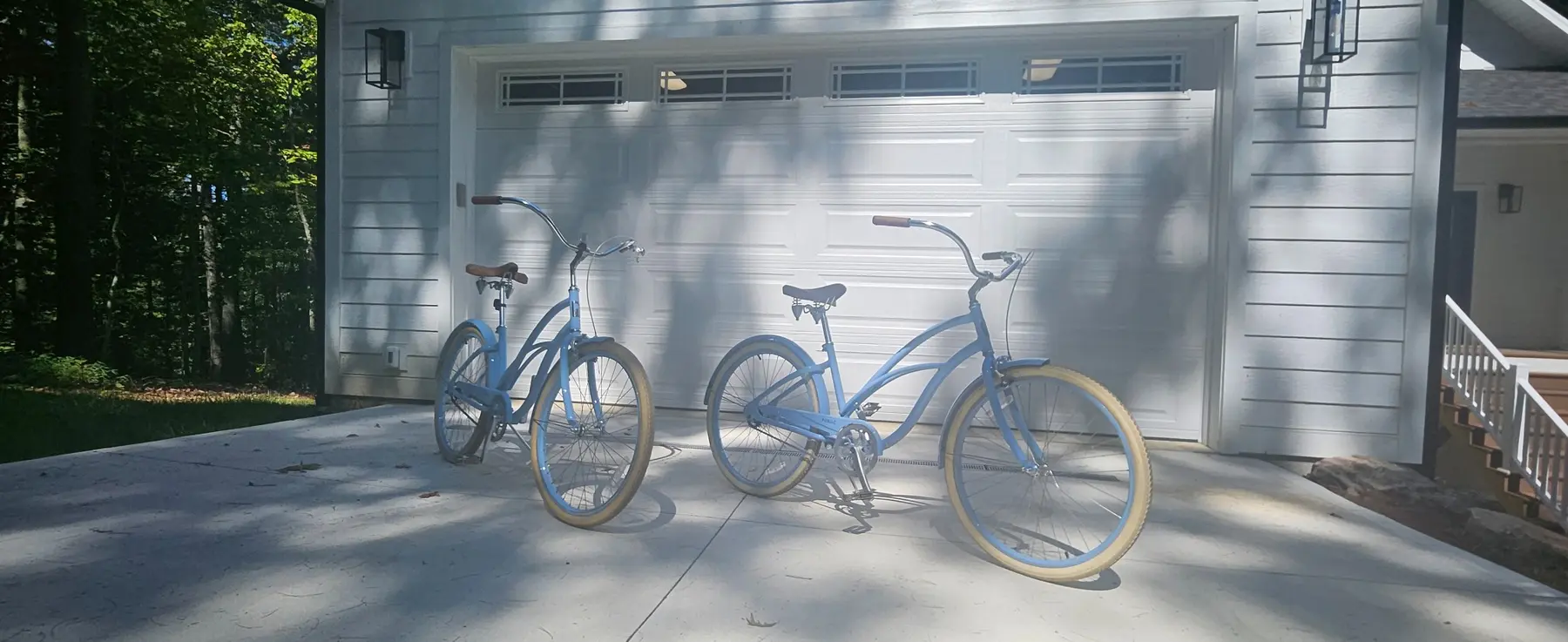 Two blue beach cruiser bicycles ready outside Oceans of Evergreen