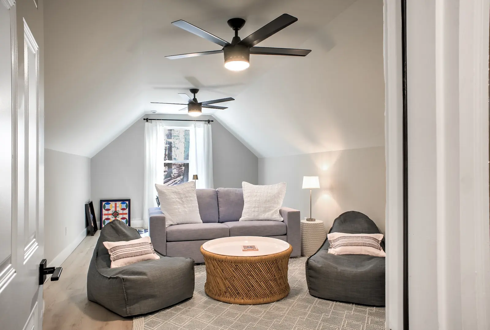 Upstairs bonus game room with relaxed lounge seating and a pull-out sofa