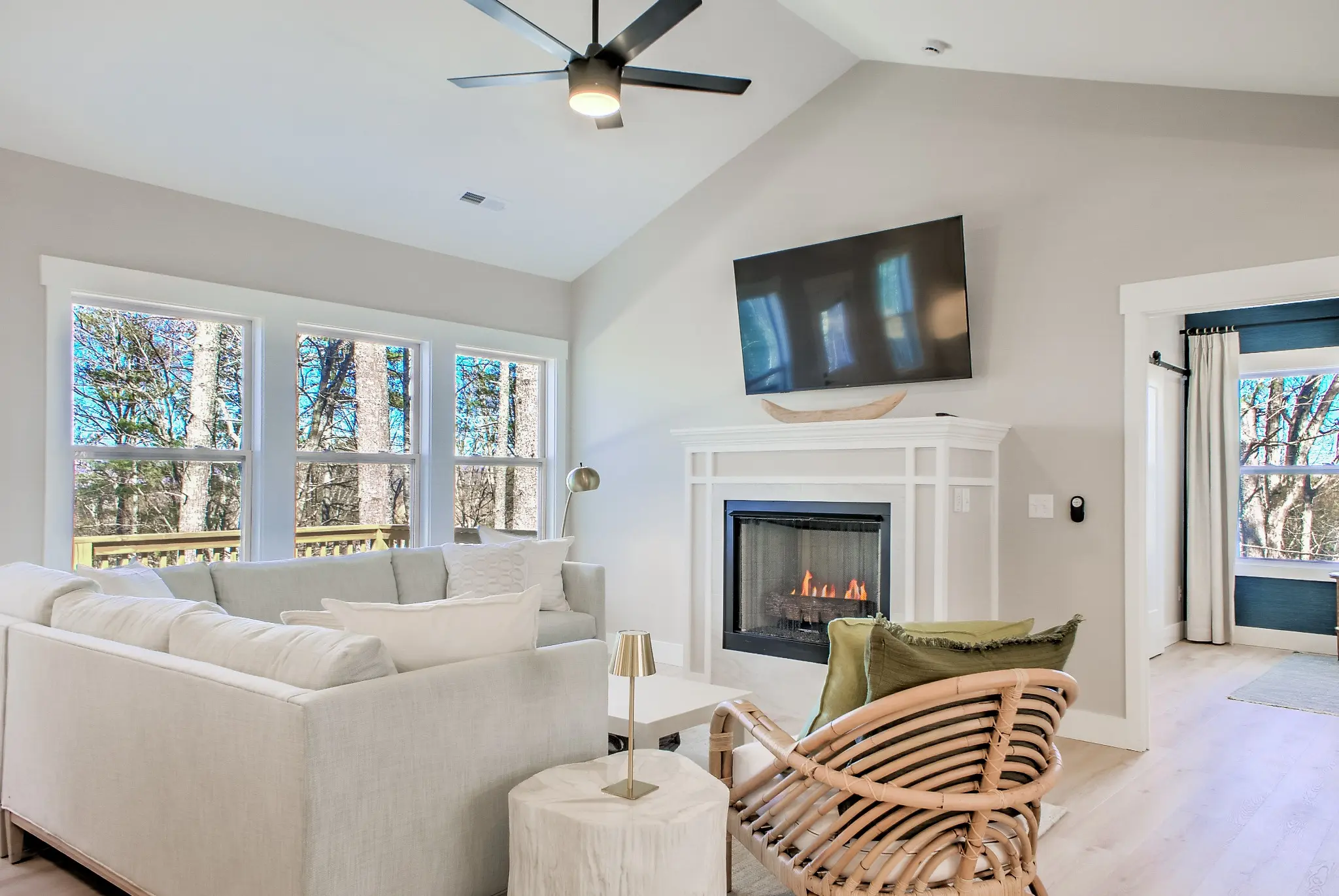 Living room seating gathered around the white fireplace